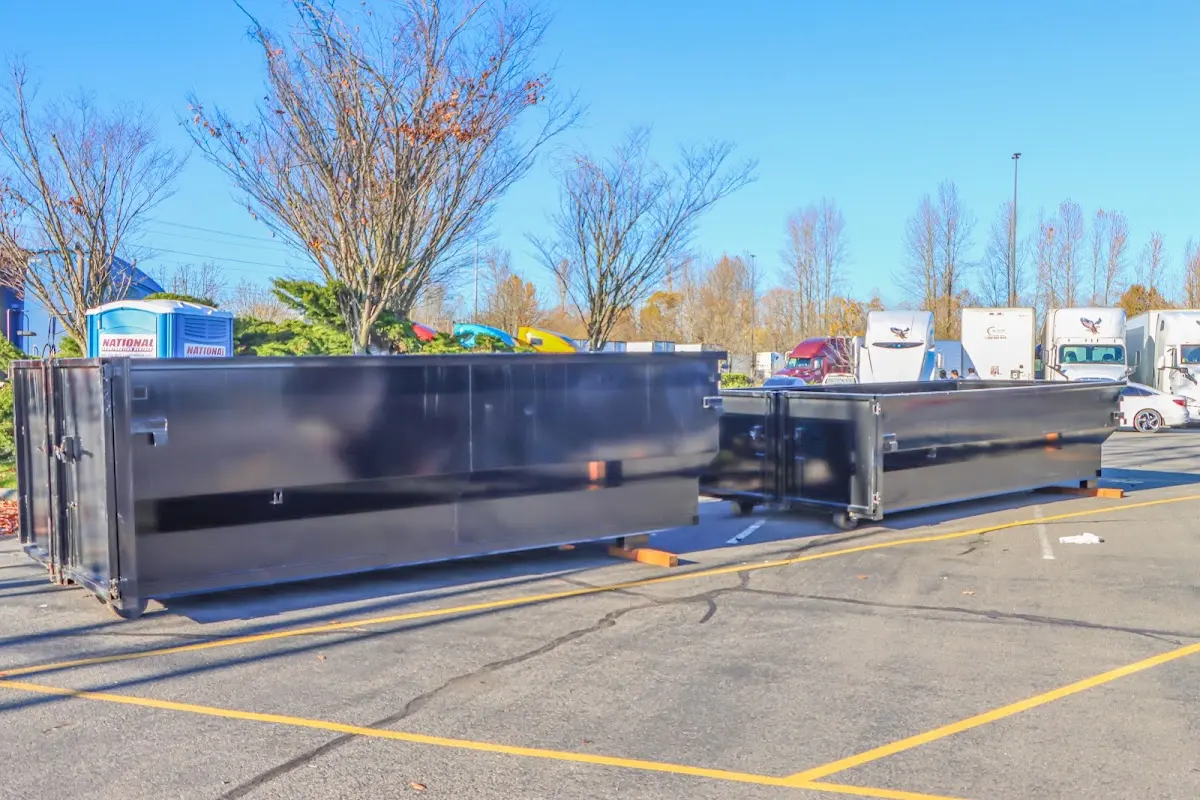 Professional dumpster rental service with roll-off container on residential driveway in Hamlet